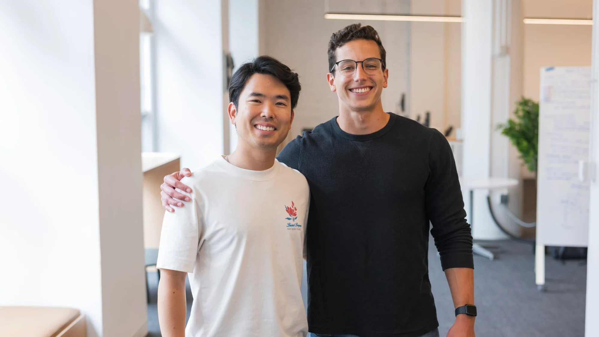 Bruno Koba and Daniel Tulha standing side by side, smiling